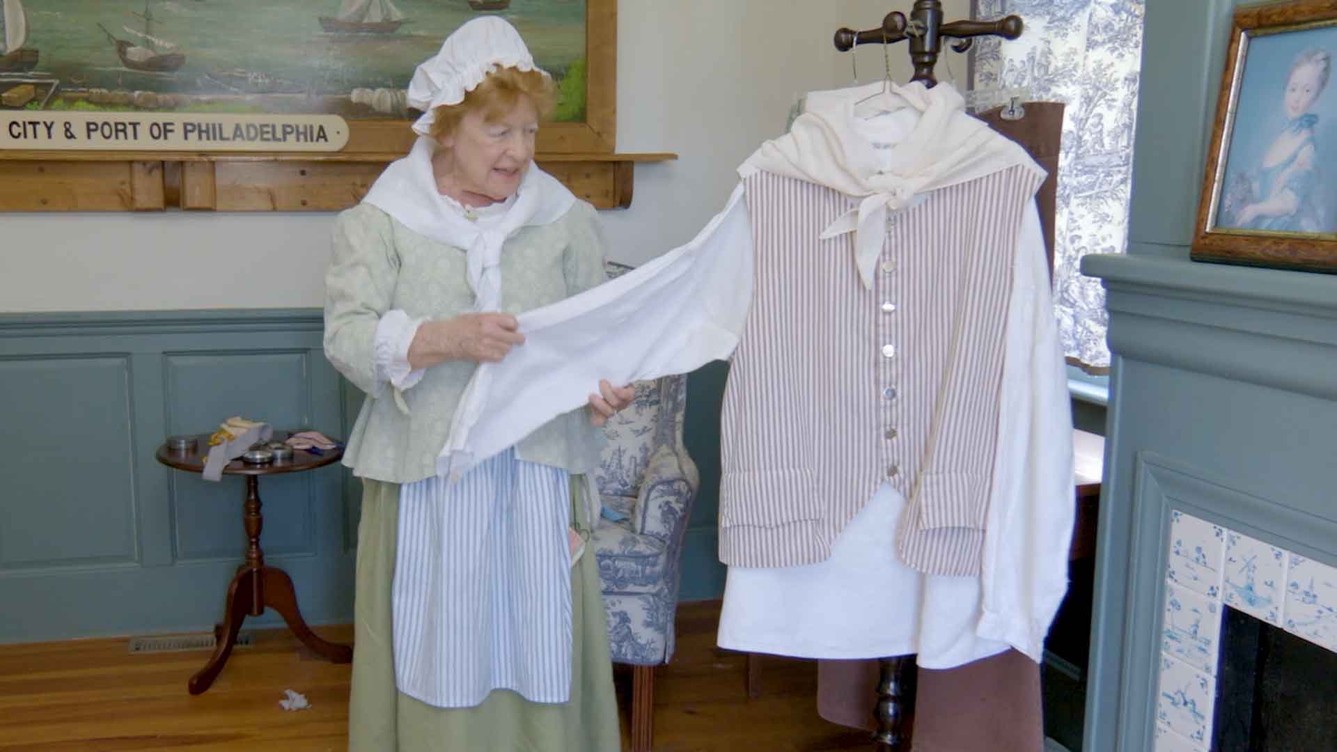 woman showing a shirt worn by men in colonial times