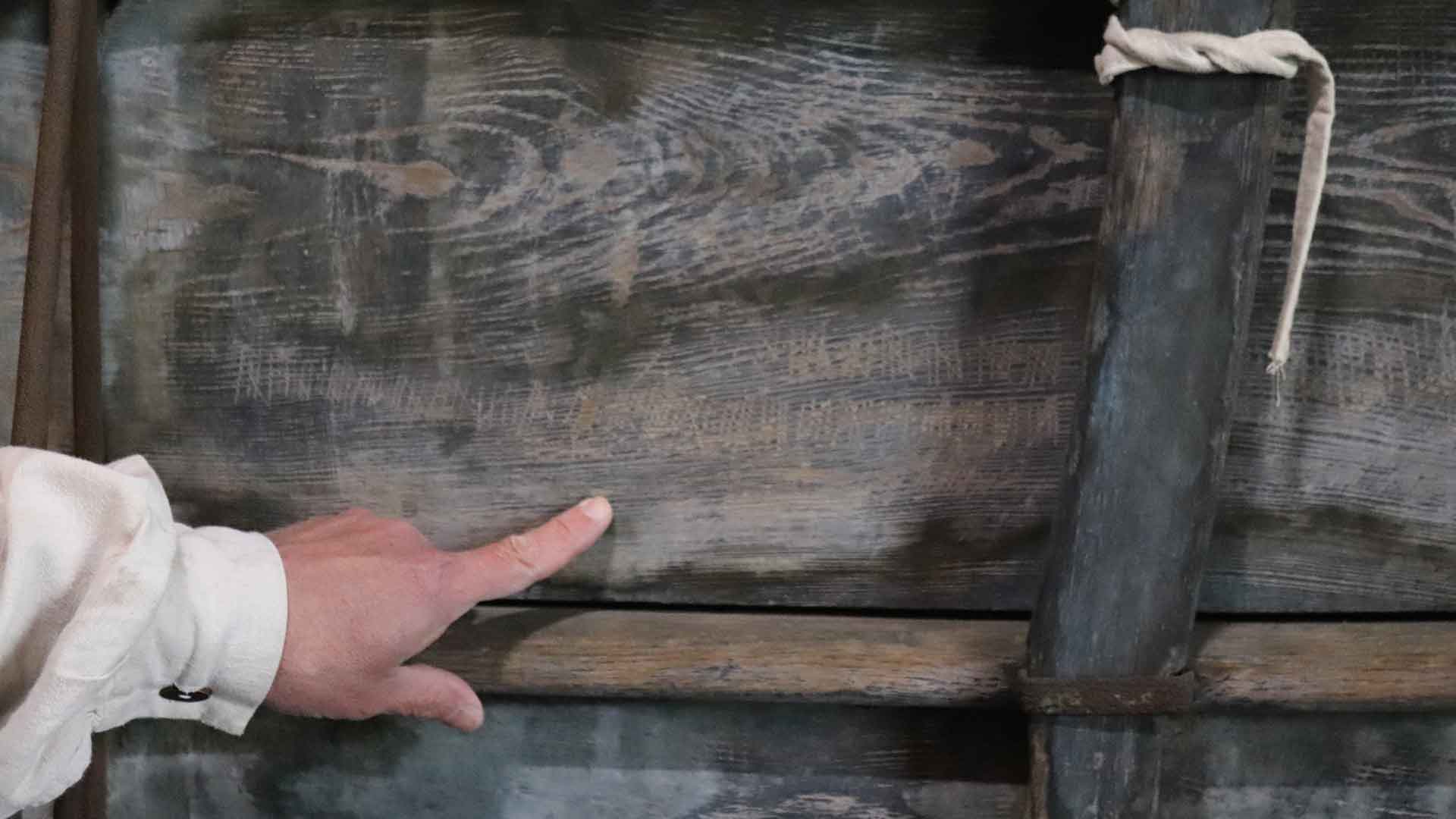 Marks carved into side of conestoga wagon