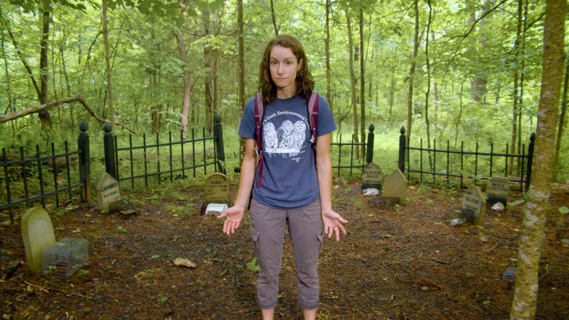 person standing in mock garbage graveyard at Shavers Creek Environmental Center