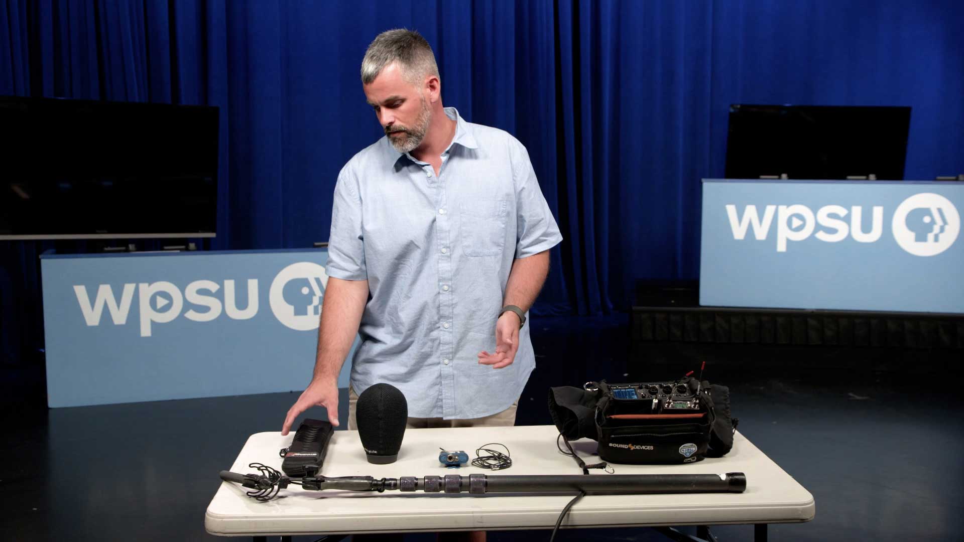 WPSU producer showing various pieces of audio equipment