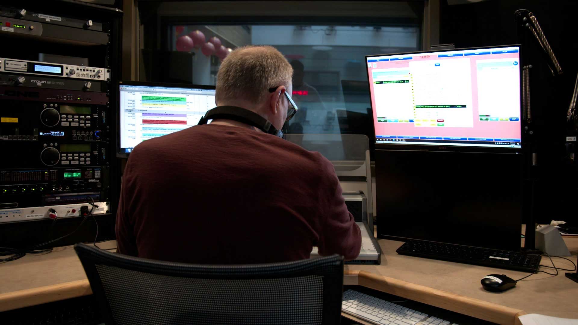 Radio producer sitting at work station