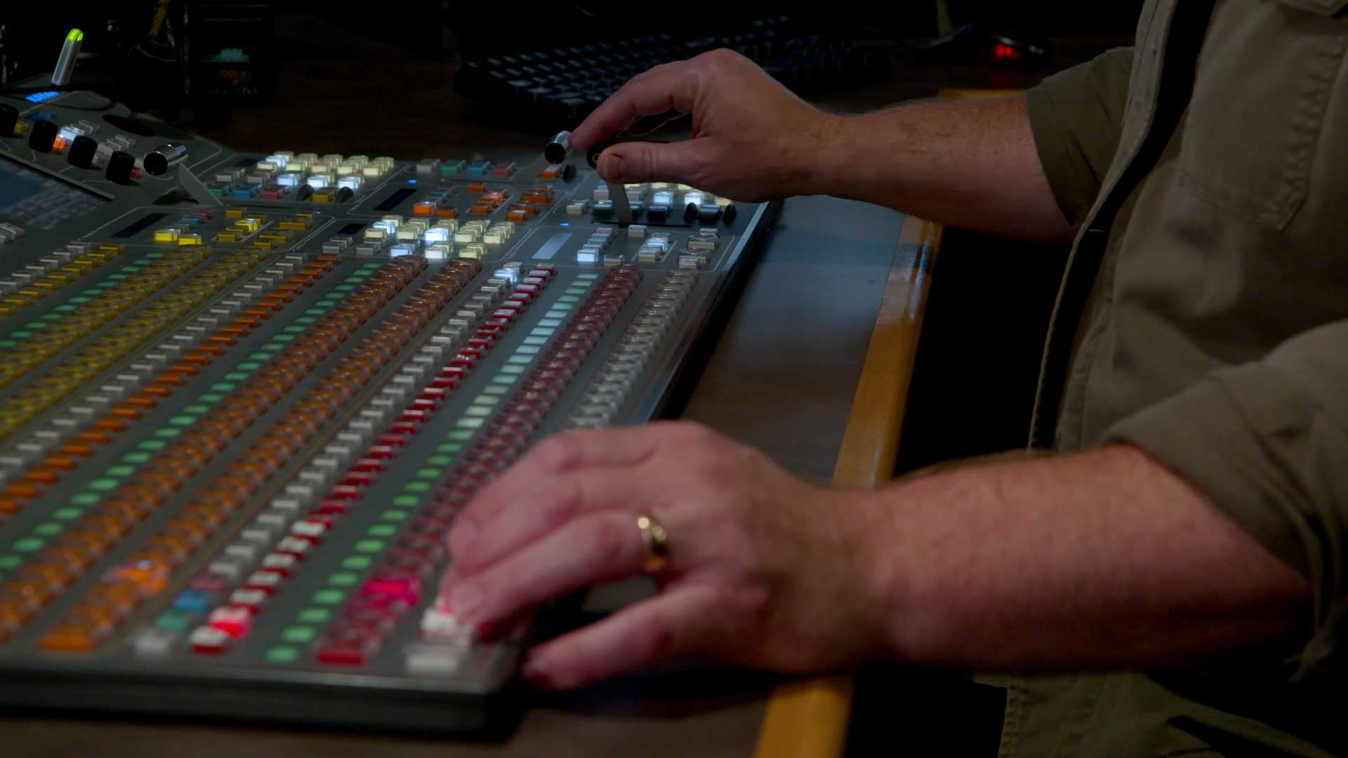 hands operating a tv studio switcher