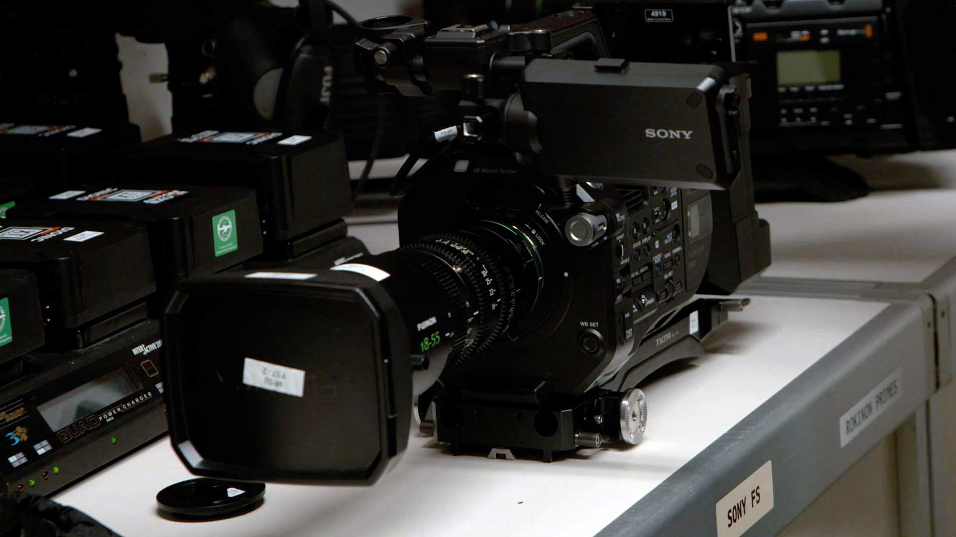 photo of video camera resting on a shelf